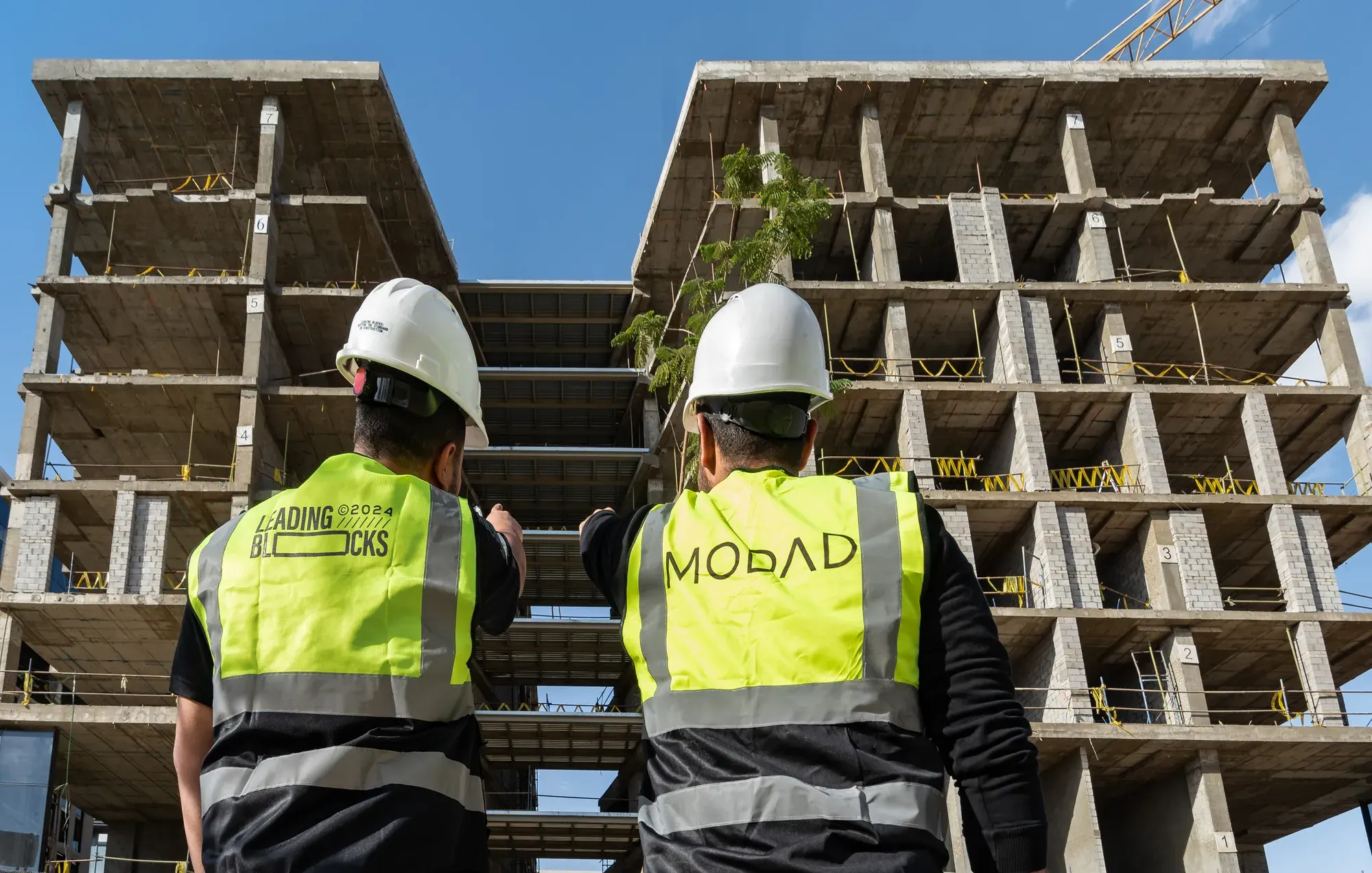 Guests in MODAD vests and hard hats looking up at the structure